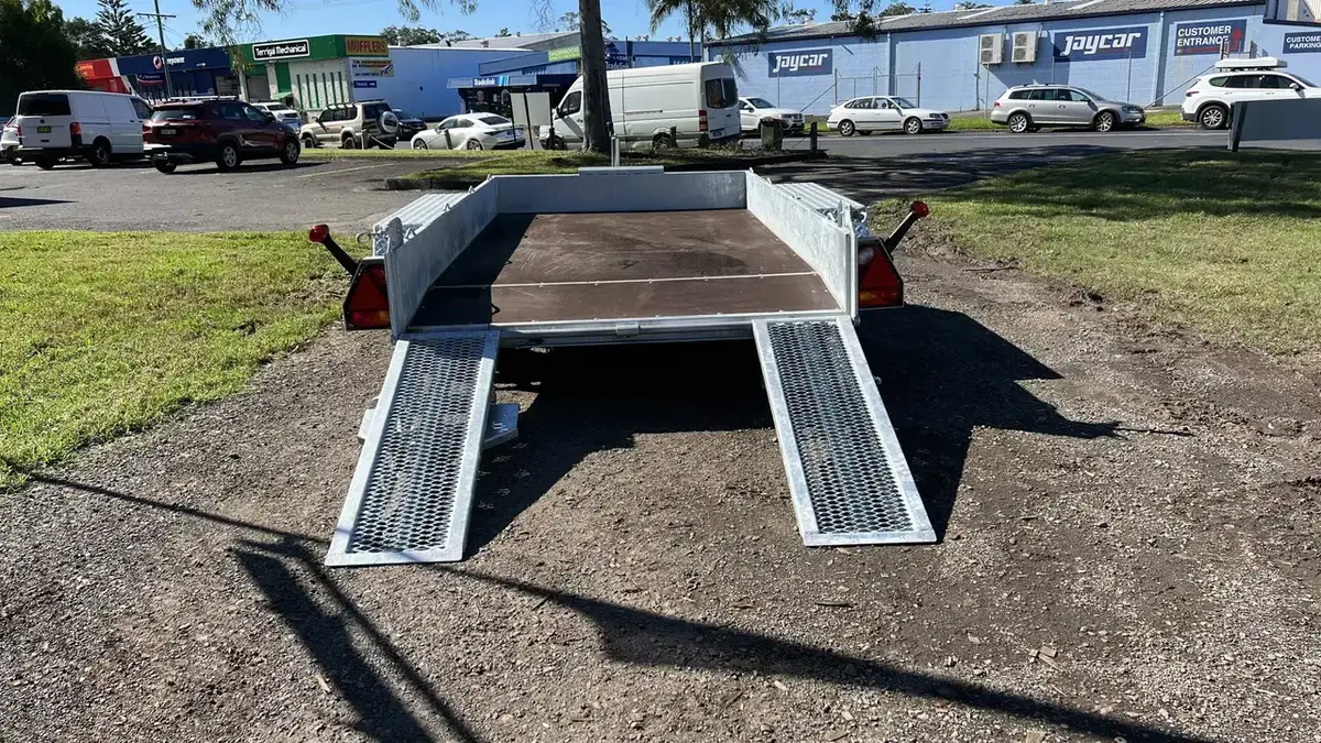 Galvanised beavertail plant trailer with its split loading ramps lowered